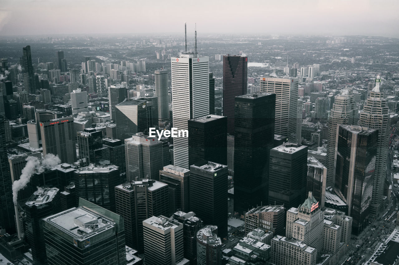 Aerial view of modern buildings in city against sky