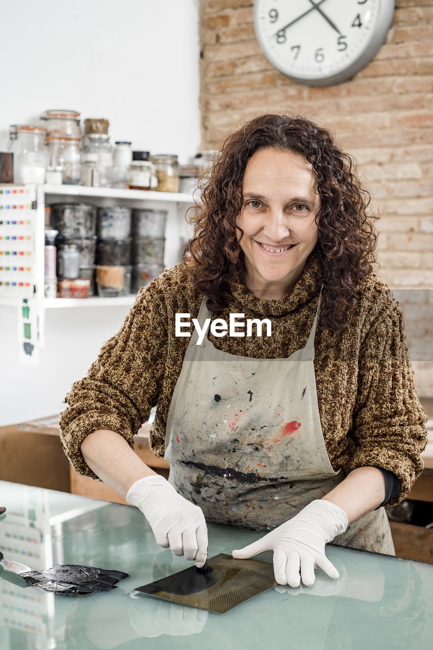 Woman artist preparing ink for an art print. using an ink stick