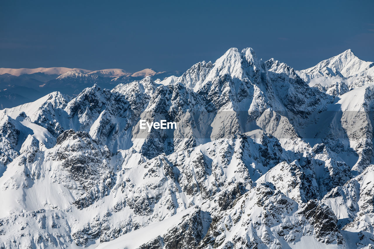 Aerial view of snowcapped mountains against sky. view from lomnica, tatra mountains, poland