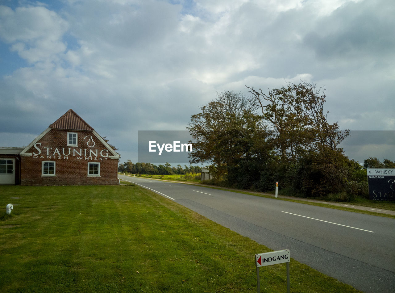 VIEW OF ROAD BY BUILDING AGAINST SKY