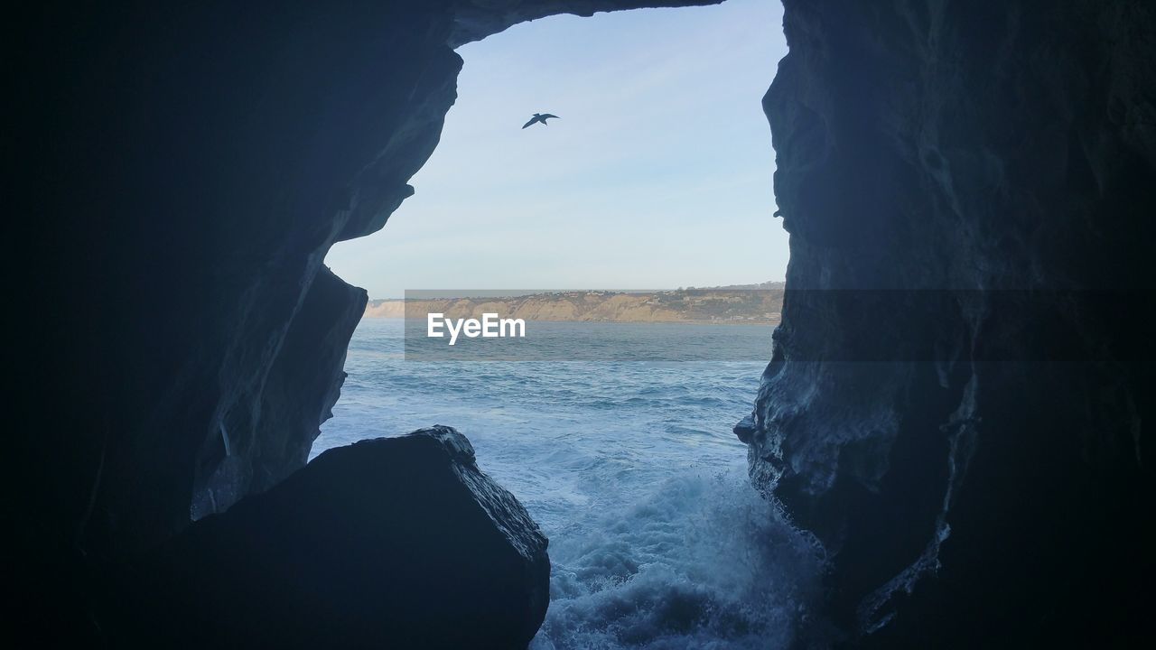 Scenic view of sea seen through cave at la jolla