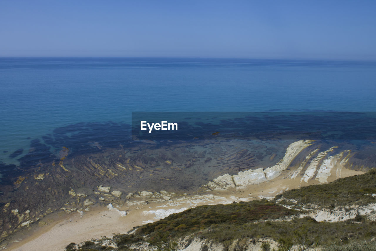 Scenic view of sea against clear blue sky