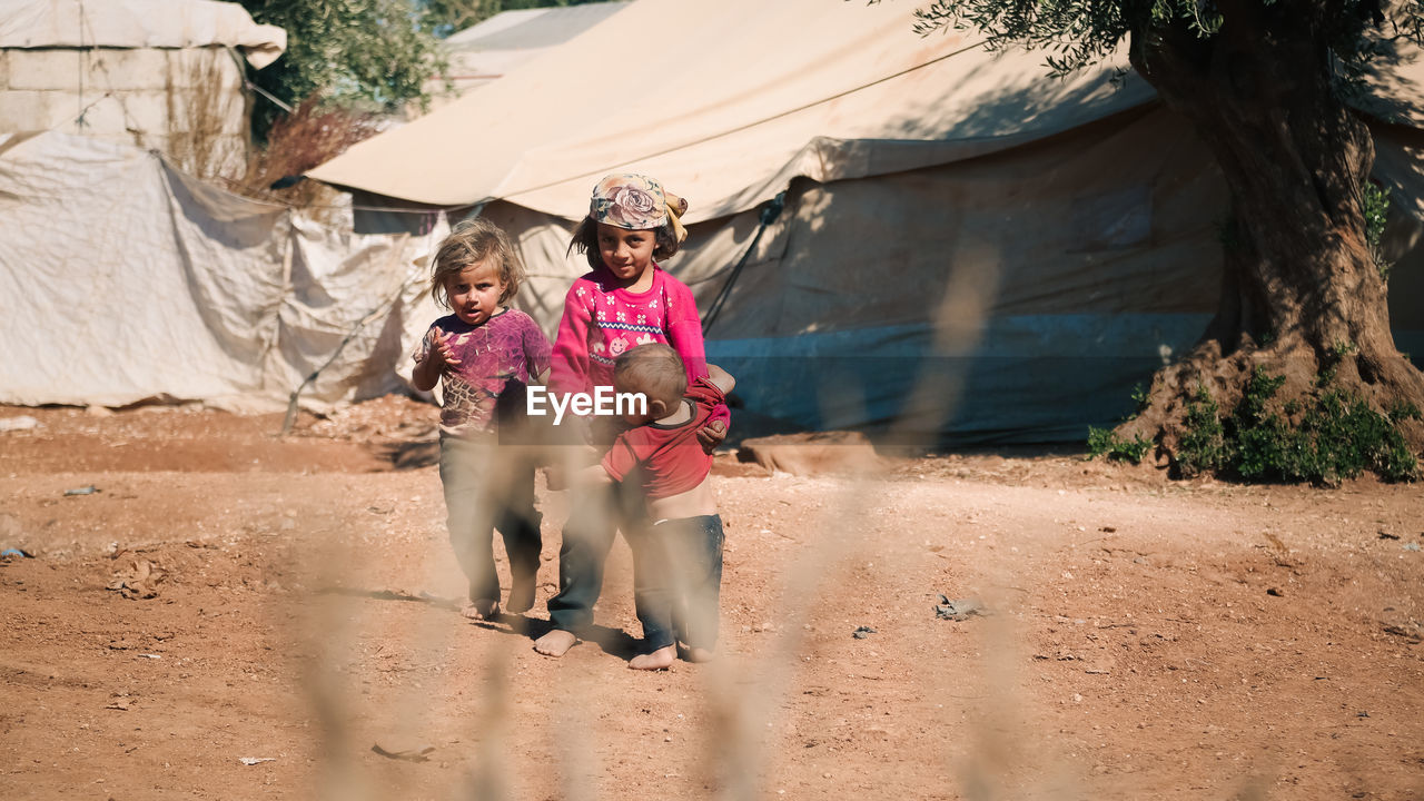 Syrian children inside their tent in the middle of a refugee camp near the turkish border.