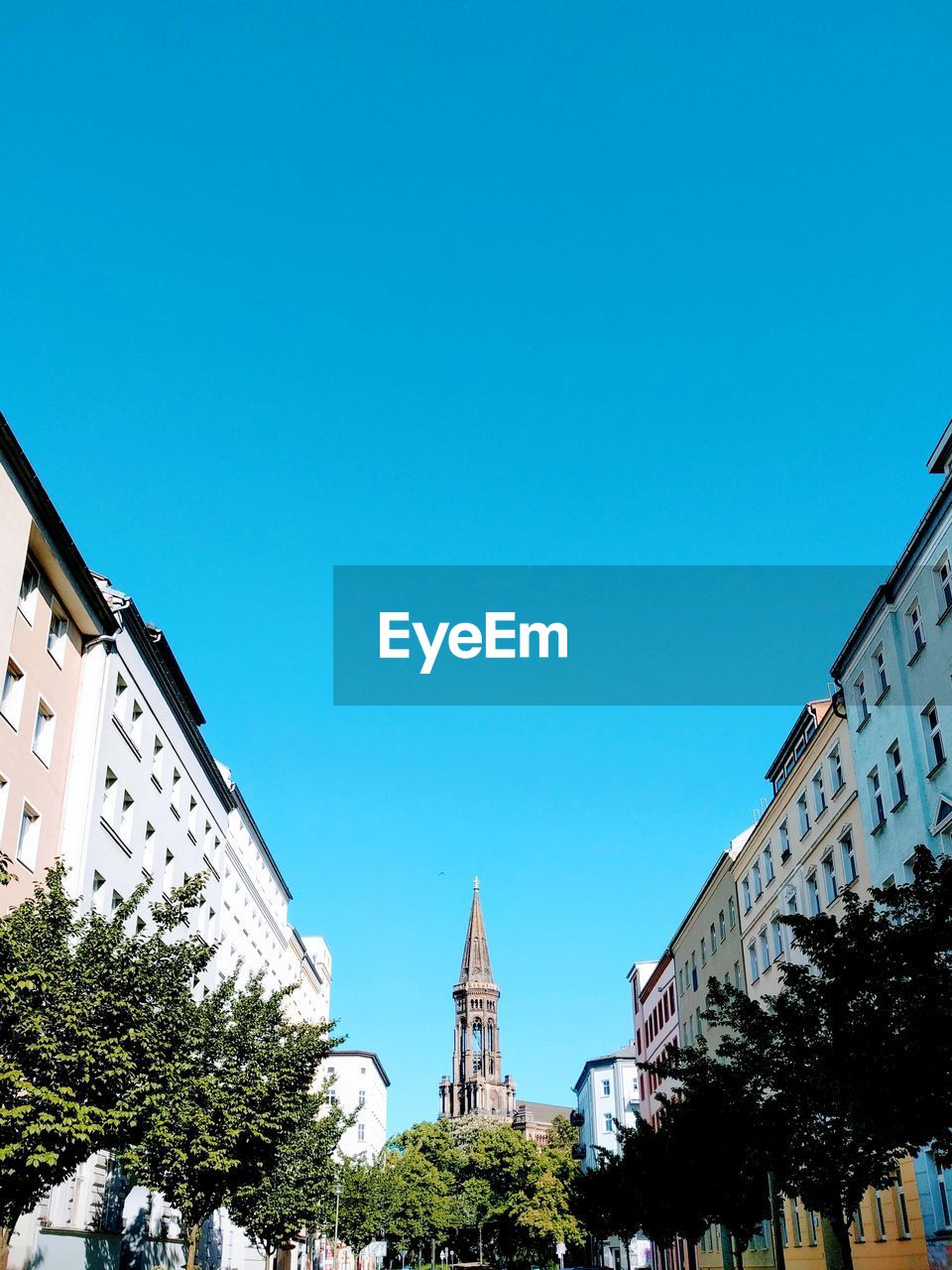 Low angle view of buildings against clear blue sky