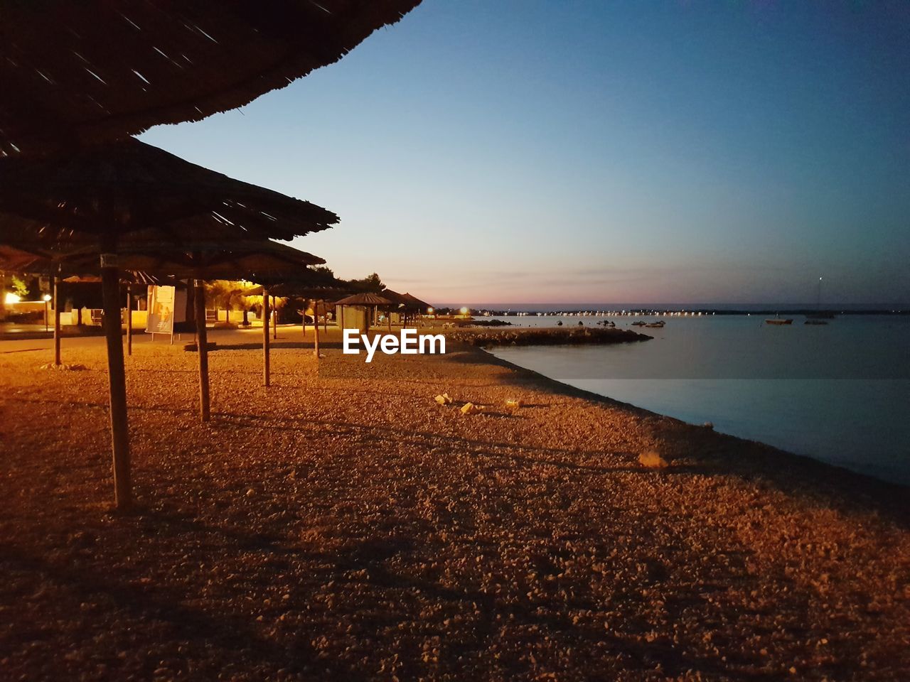 Scenic view of sea against clear sky at sunset