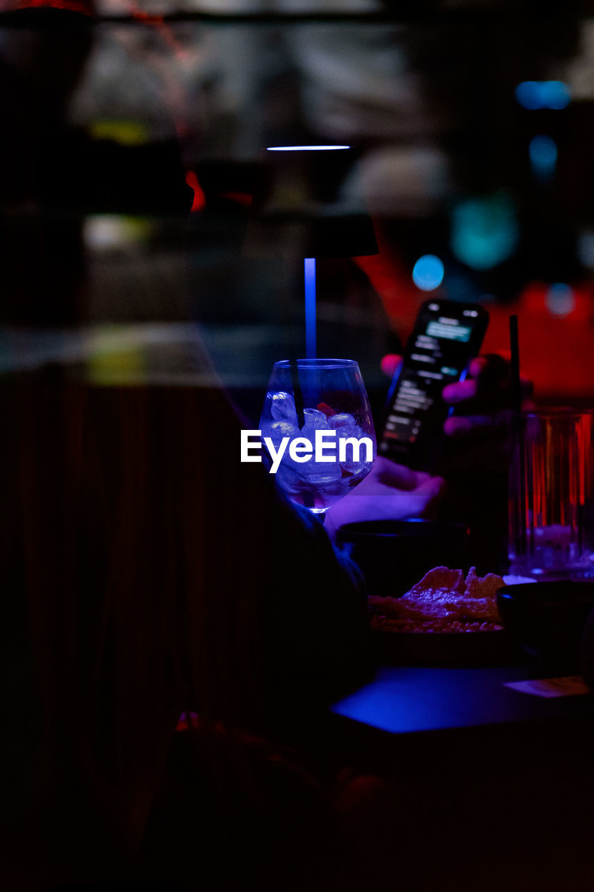 nightlife, indoors, darkness, nightclub, night, light, stage, glass, red, bar, alcohol, arts culture and entertainment, blue, drink, music, drinking glass, performance, bar counter, bottle, refreshment, no people, household equipment, dark, illuminated