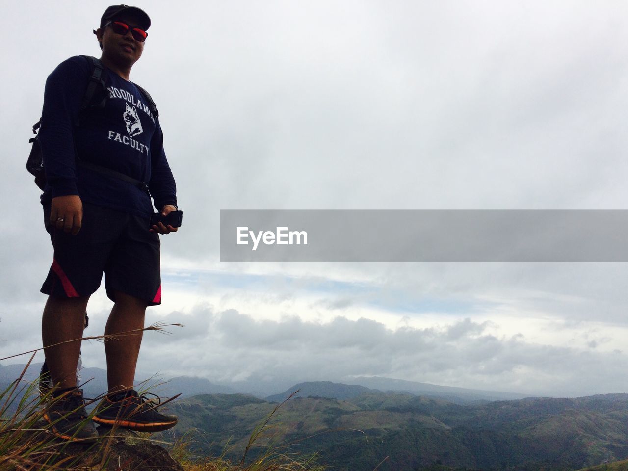 WOMAN STANDING ON TOP OF MOUNTAIN