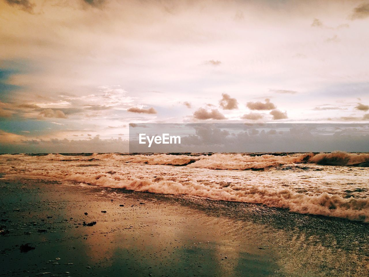 Scenic view of beach and sea against sky during sunset