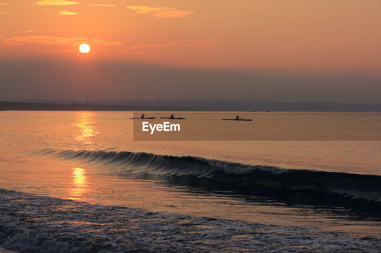 Scenic view of sea against orange sky