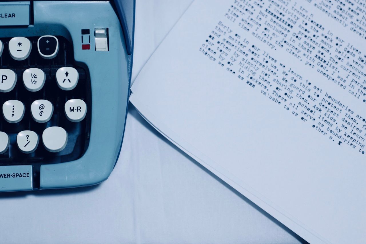 High angle view of typewriter with papers on table