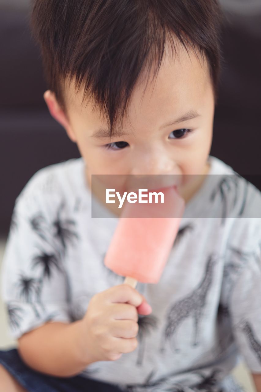 Close-up portrait of boy eating ice cream