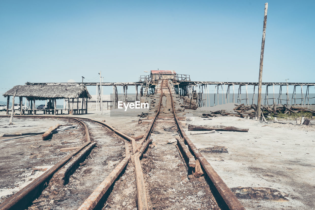 Abandoned railway bridge against clear sky during sunny day