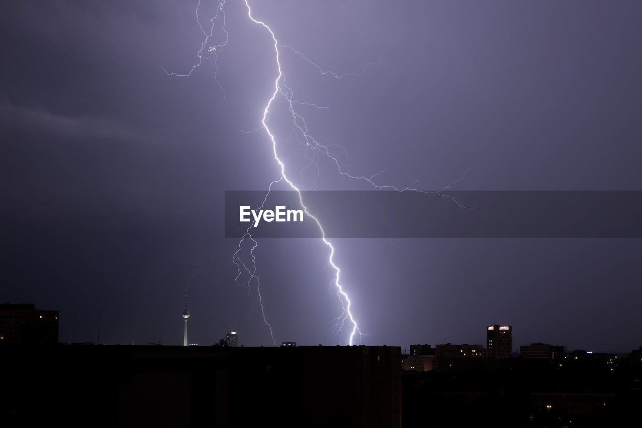 Lightning in sky over city at night