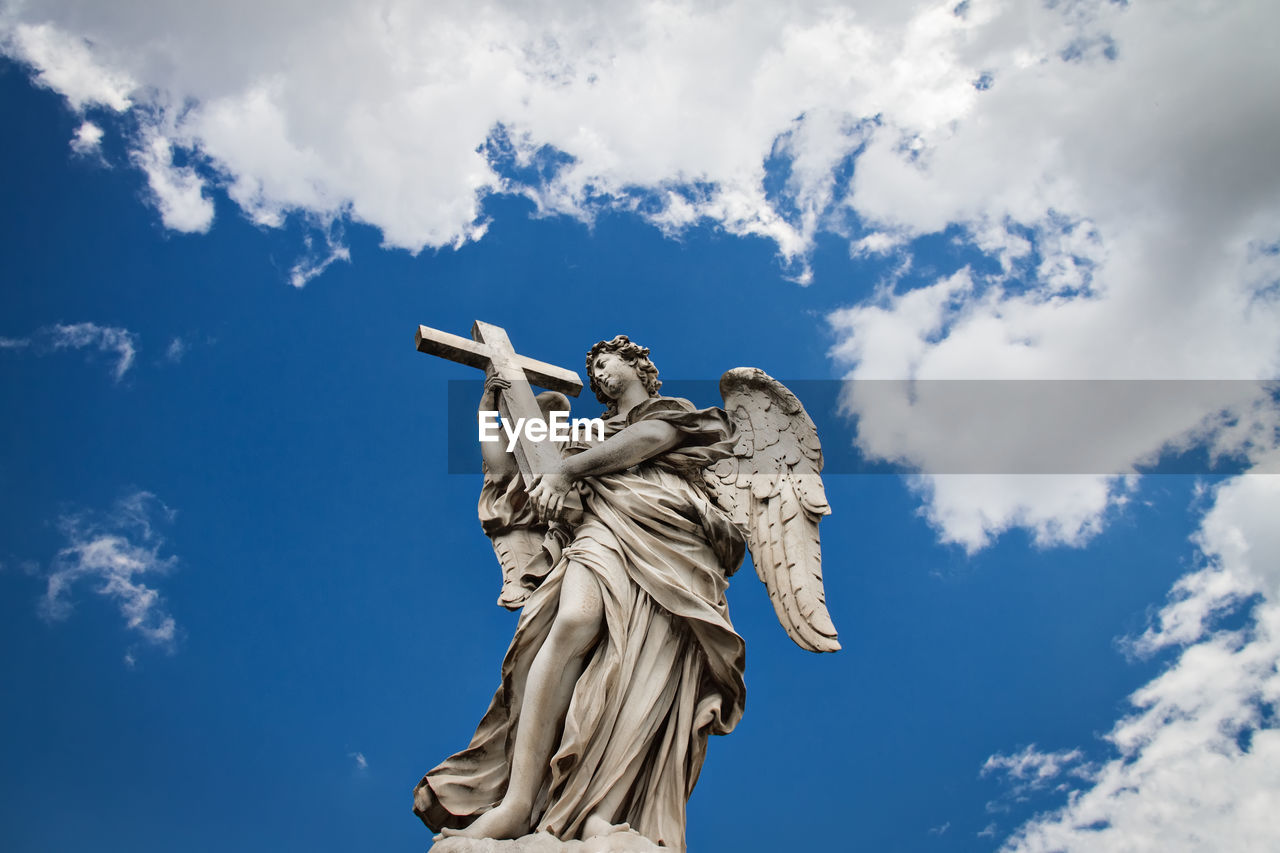 LOW ANGLE VIEW OF STATUES AGAINST SKY