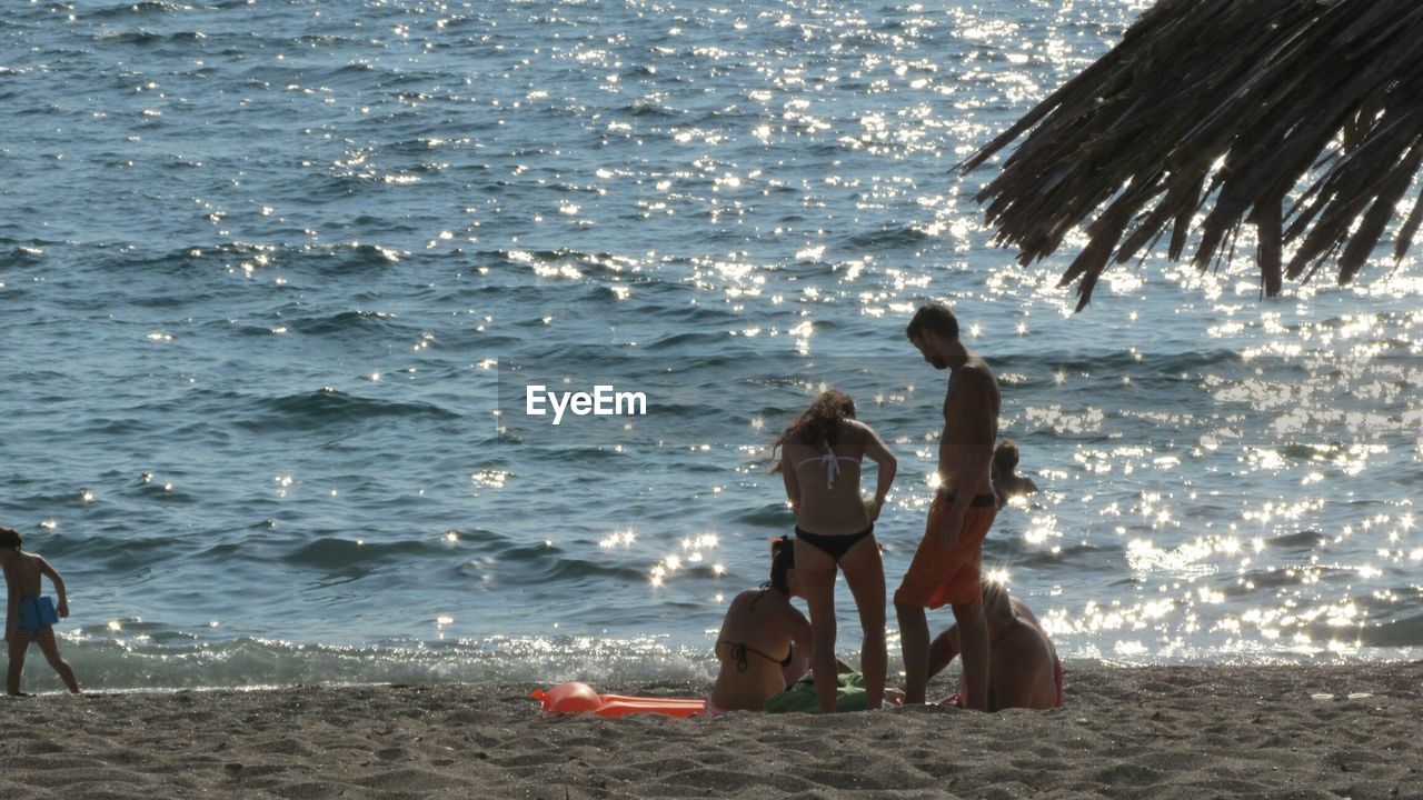 PEOPLE RELAXING ON SHORE