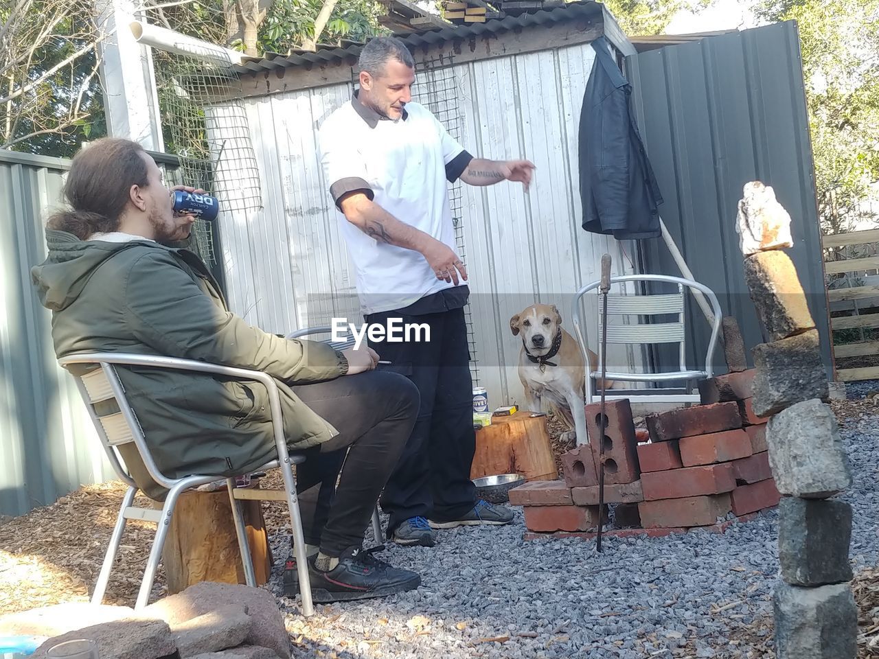 PEOPLE PHOTOGRAPHING WHILE SITTING ON SEAT