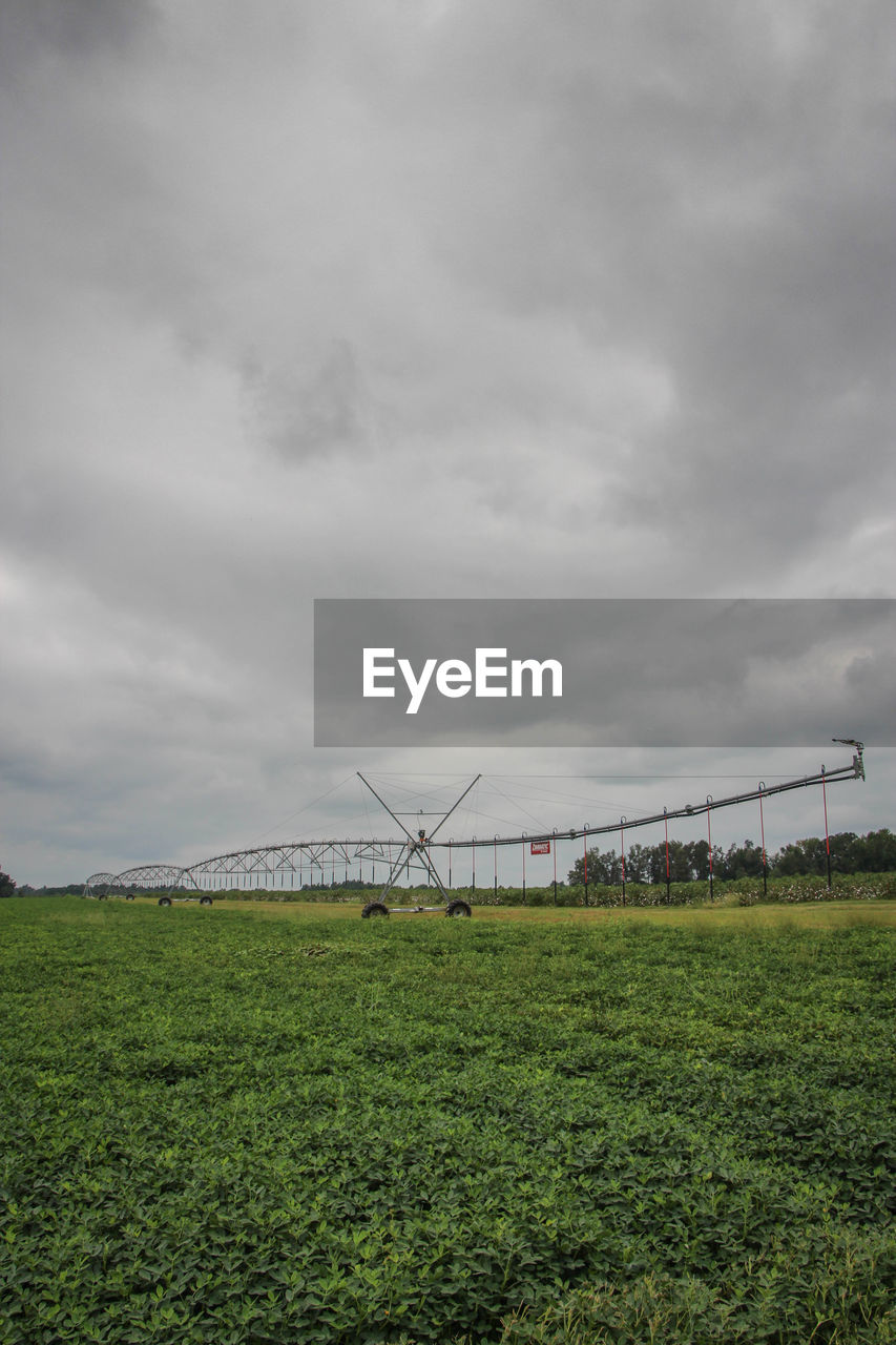 View of grassy field against cloudy sky