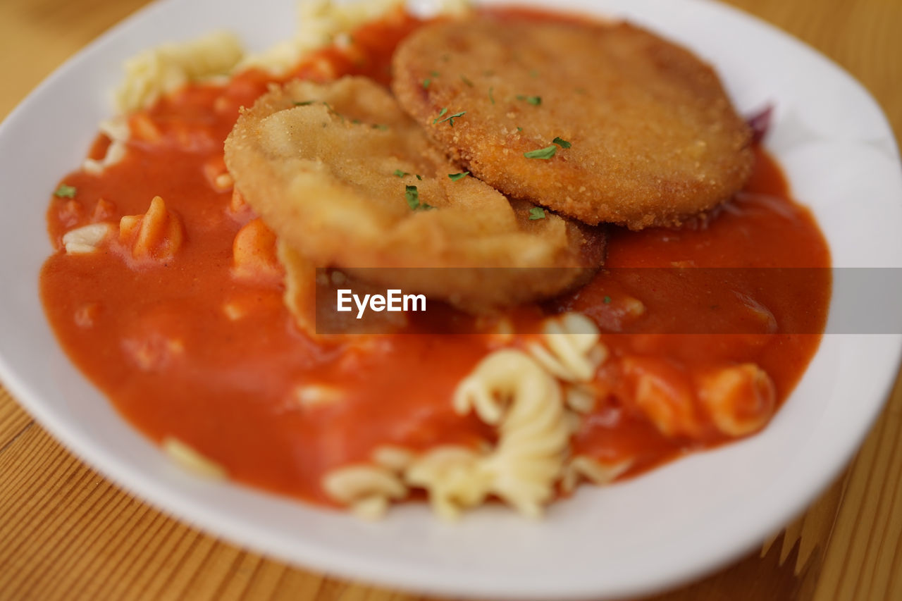 Close-up of escalope chasseur/breaded hunting sausage served in plate