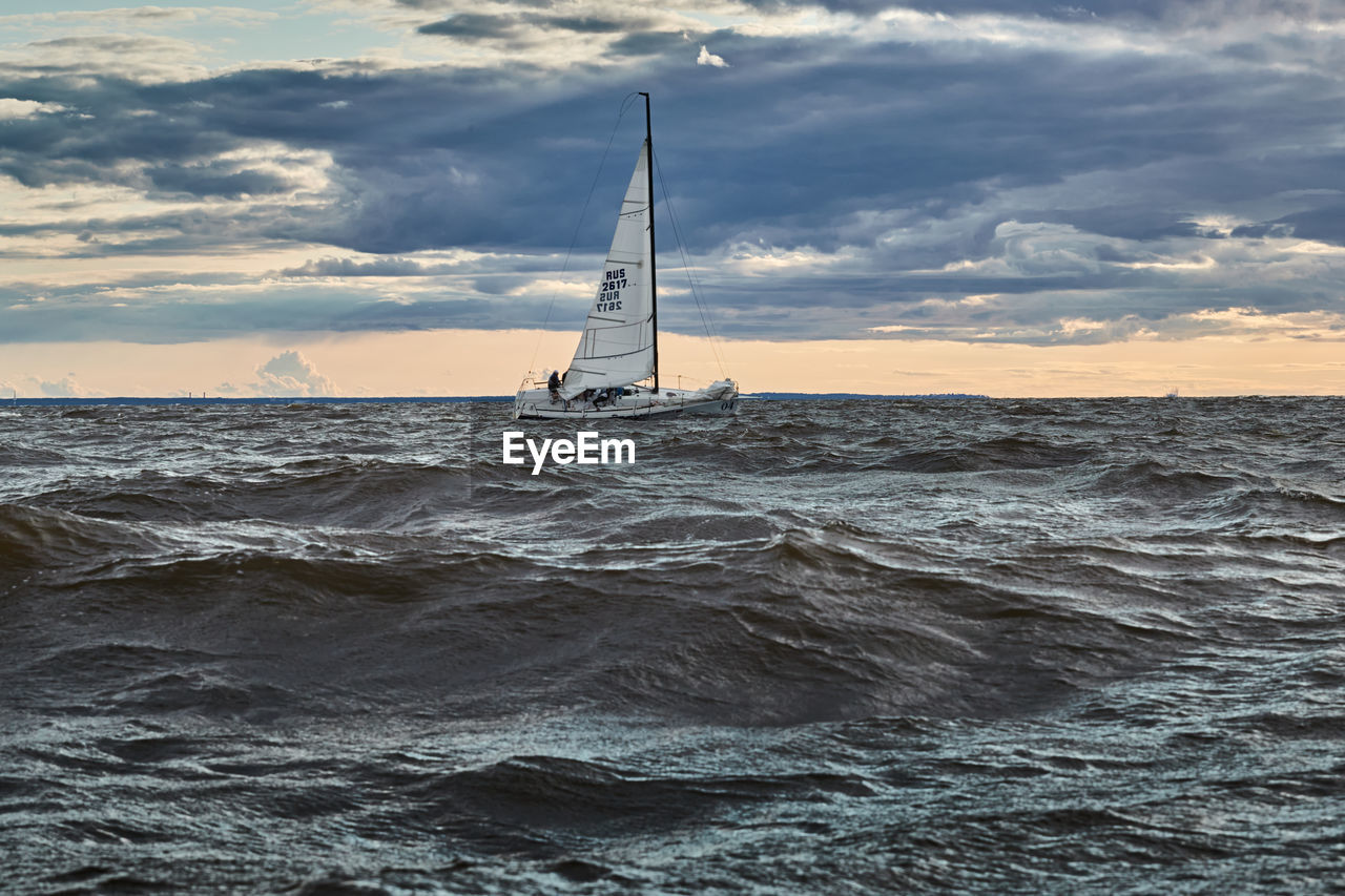 SAILBOAT ON SEA AGAINST SKY DURING SUNSET