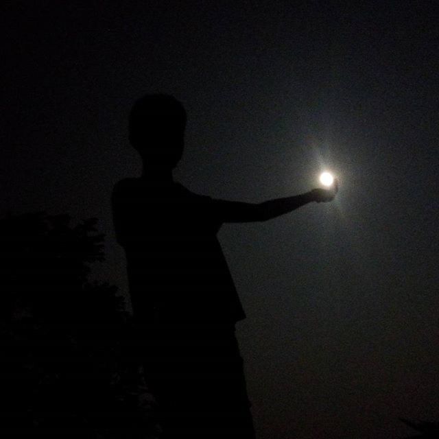 LOW ANGLE VIEW OF SILHOUETTE PEOPLE IN DARK ROOM