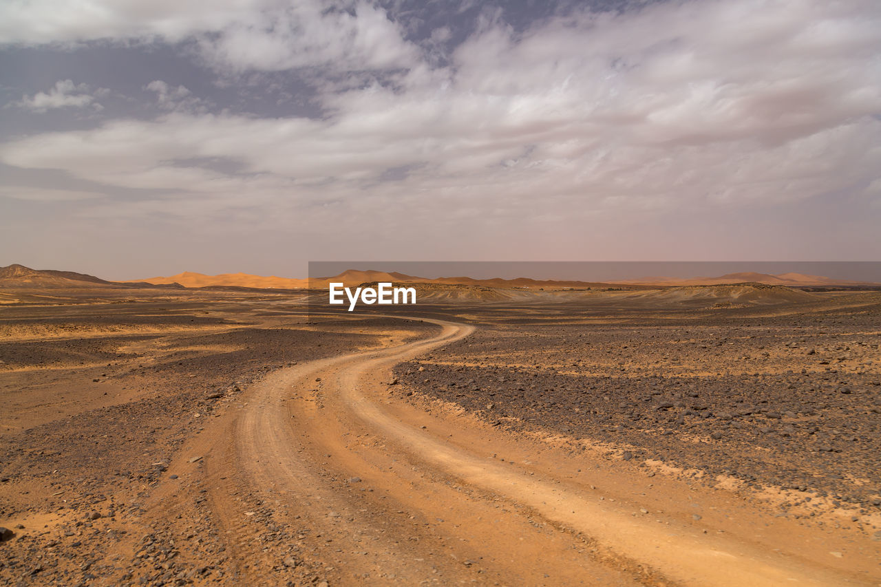 Dirt road passing through a desert