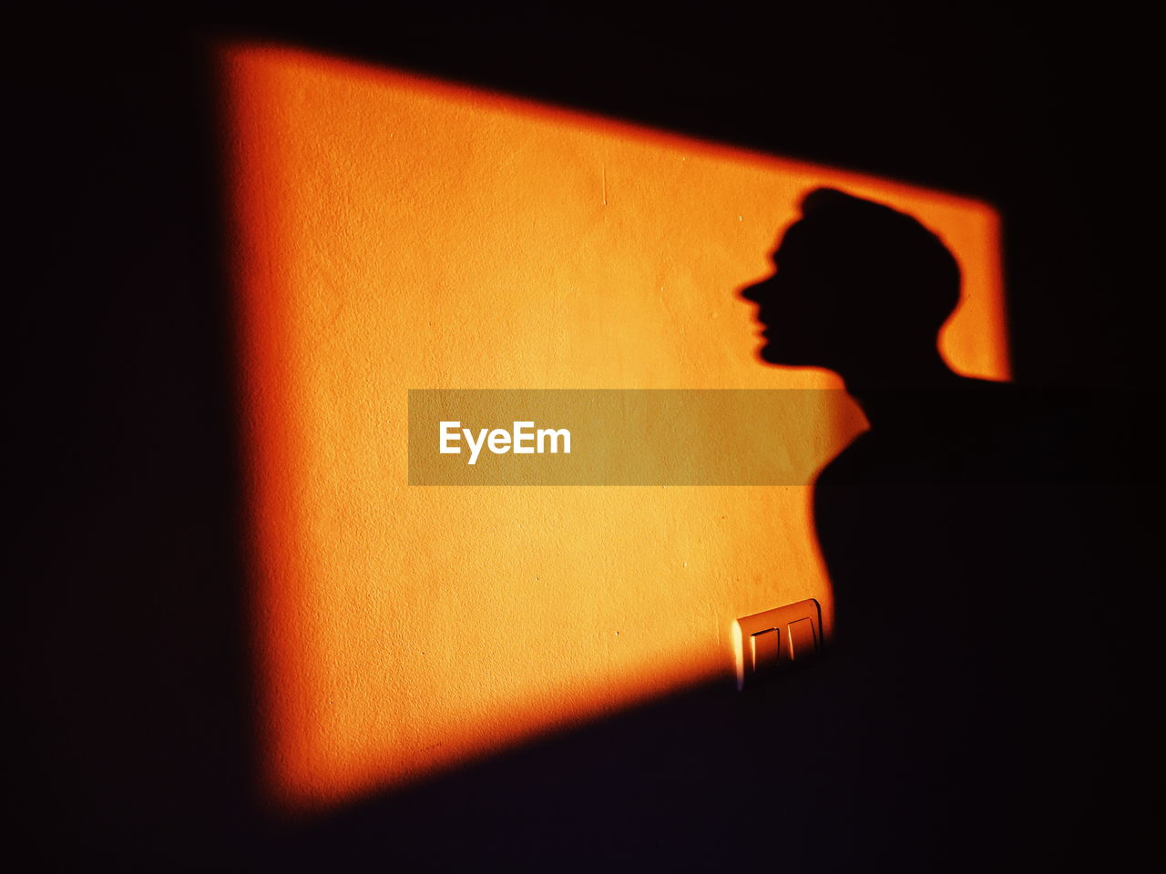 Shadow of man on wall at night