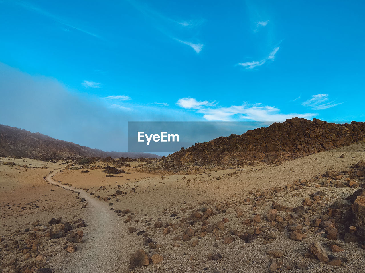 Scenic view of arid landscape against sky