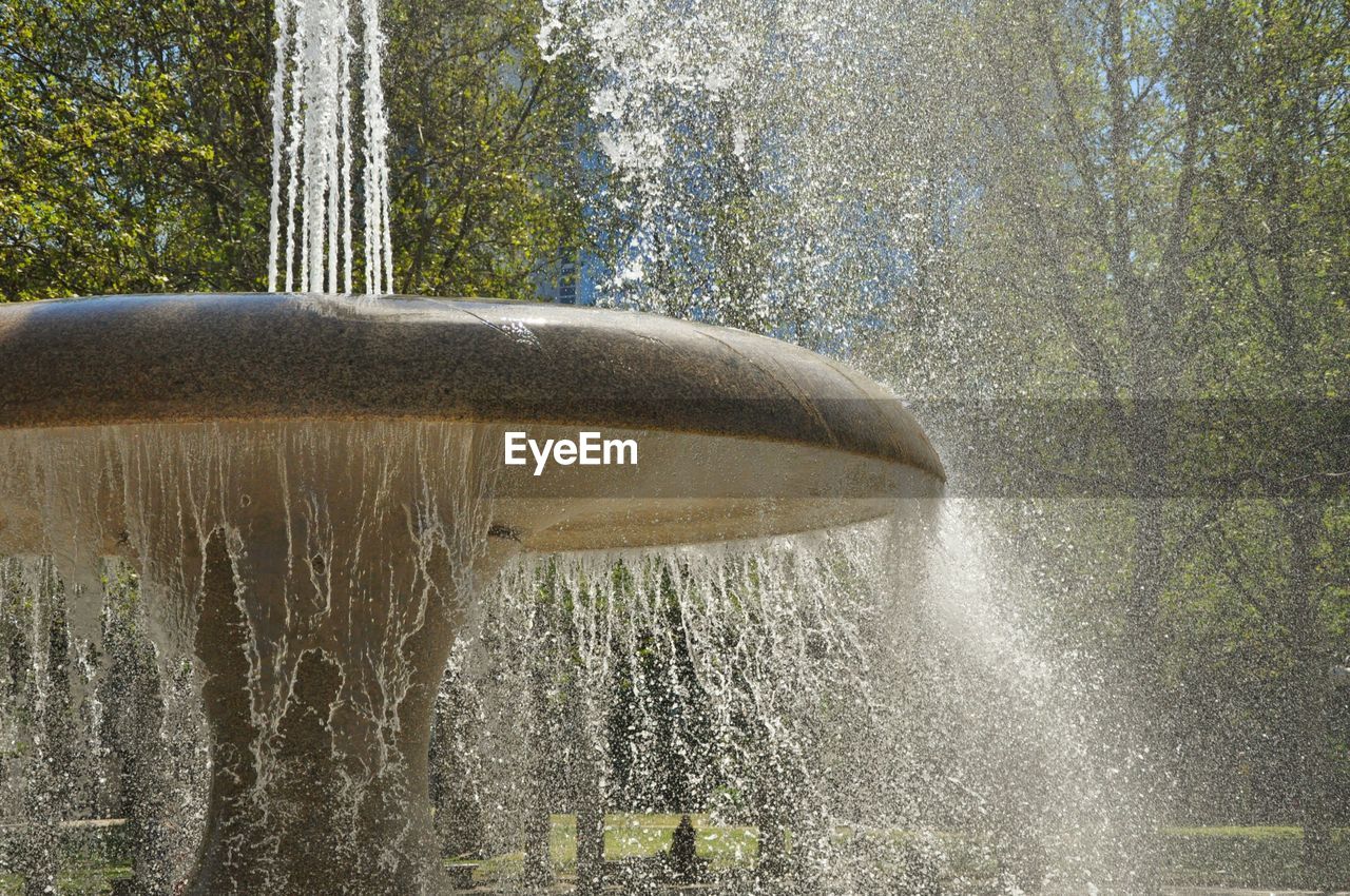 Fountain spraying water in park