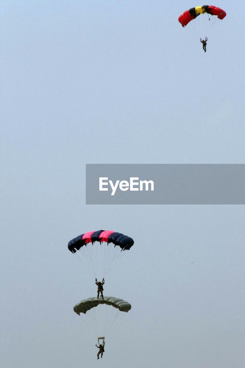 Troops parachuting against clear sky