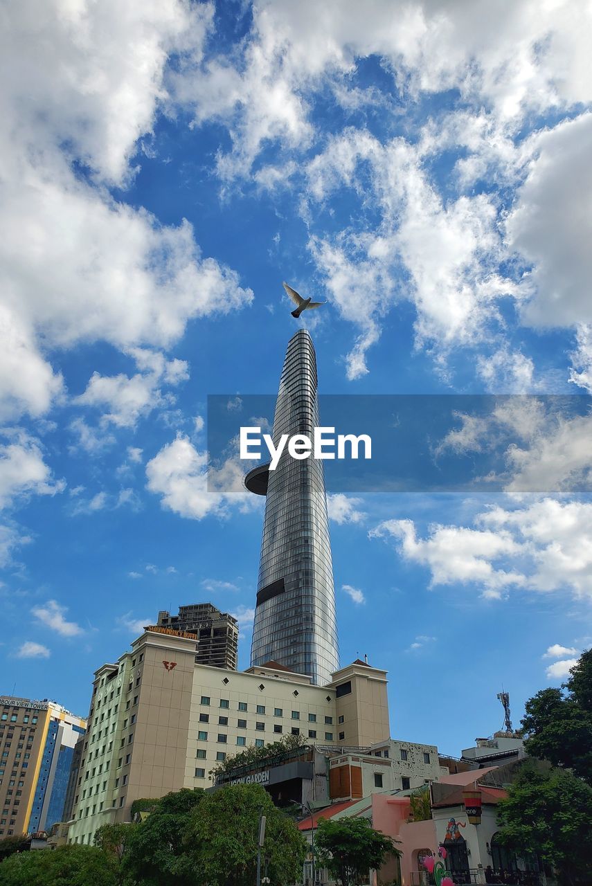 Low angle view of buildings against cloudy sky