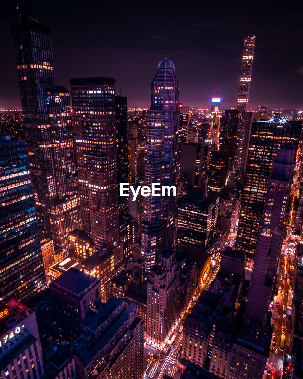 Aerial view of illuminated buildings in city at night