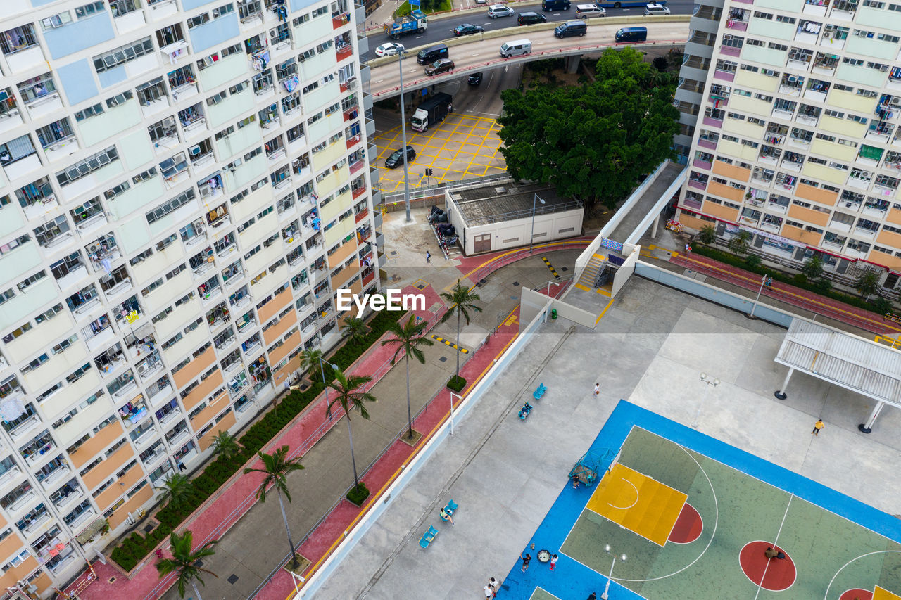 High angle view of buildings by playground in city