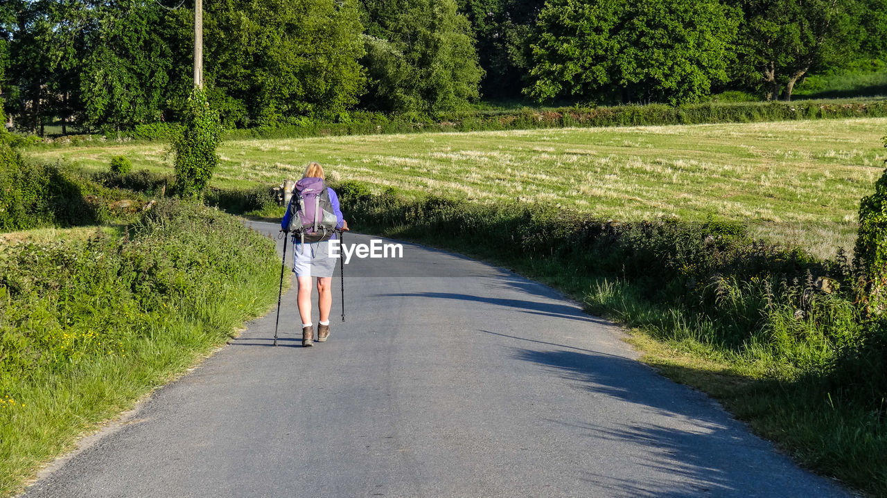 Rear view of woman walking at camino de santiago