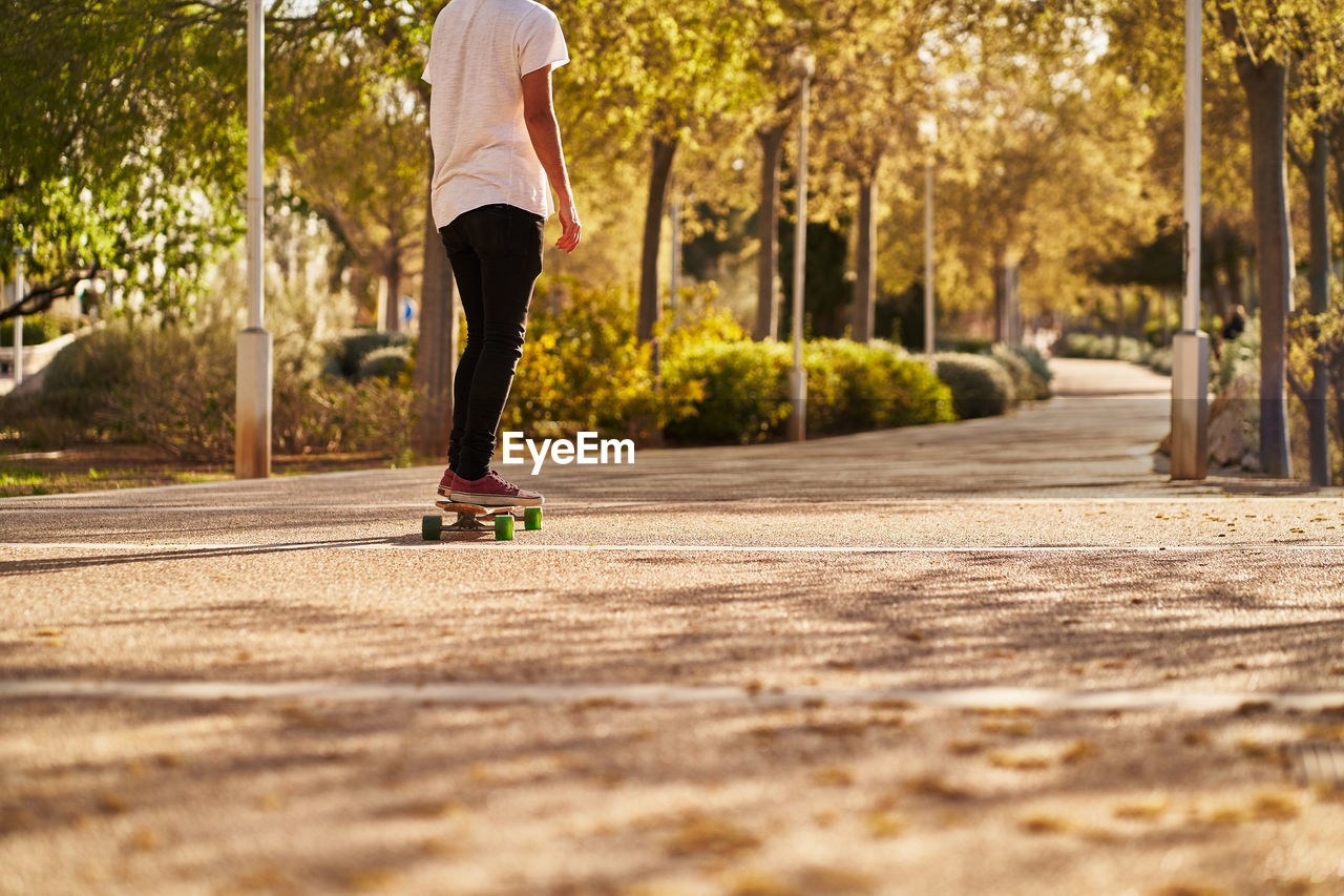 Low section of woman running on footpath