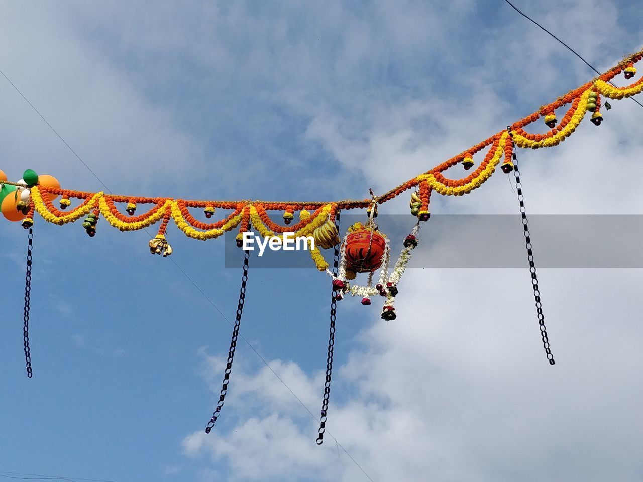 Low angle view of dahi handi decorations against sky