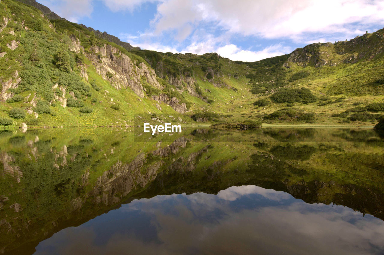 Scenic view of lake and mountains against sky