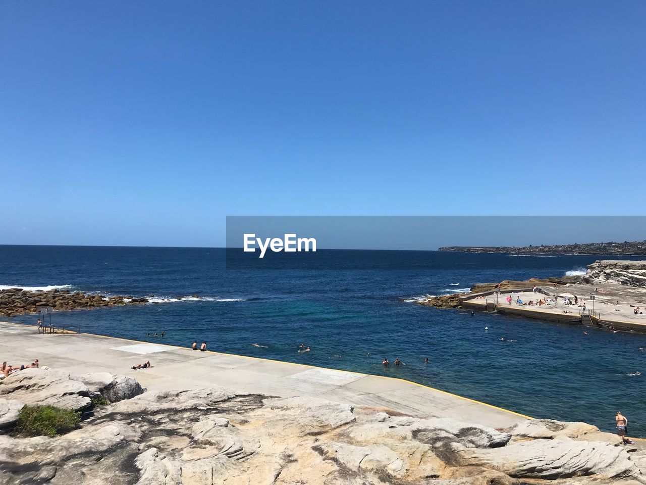 Scenic view of sea against clear blue sky