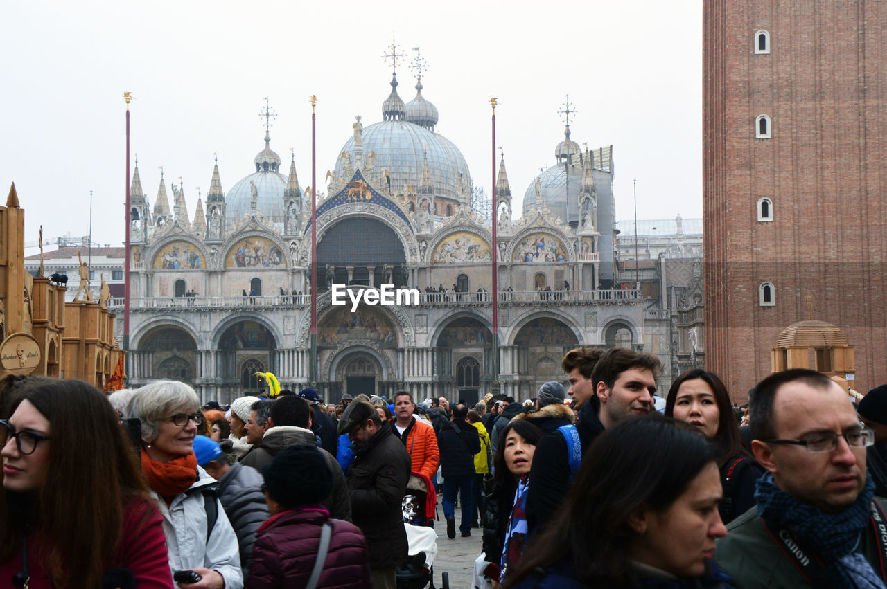 PEOPLE AT TEMPLE AGAINST SKY