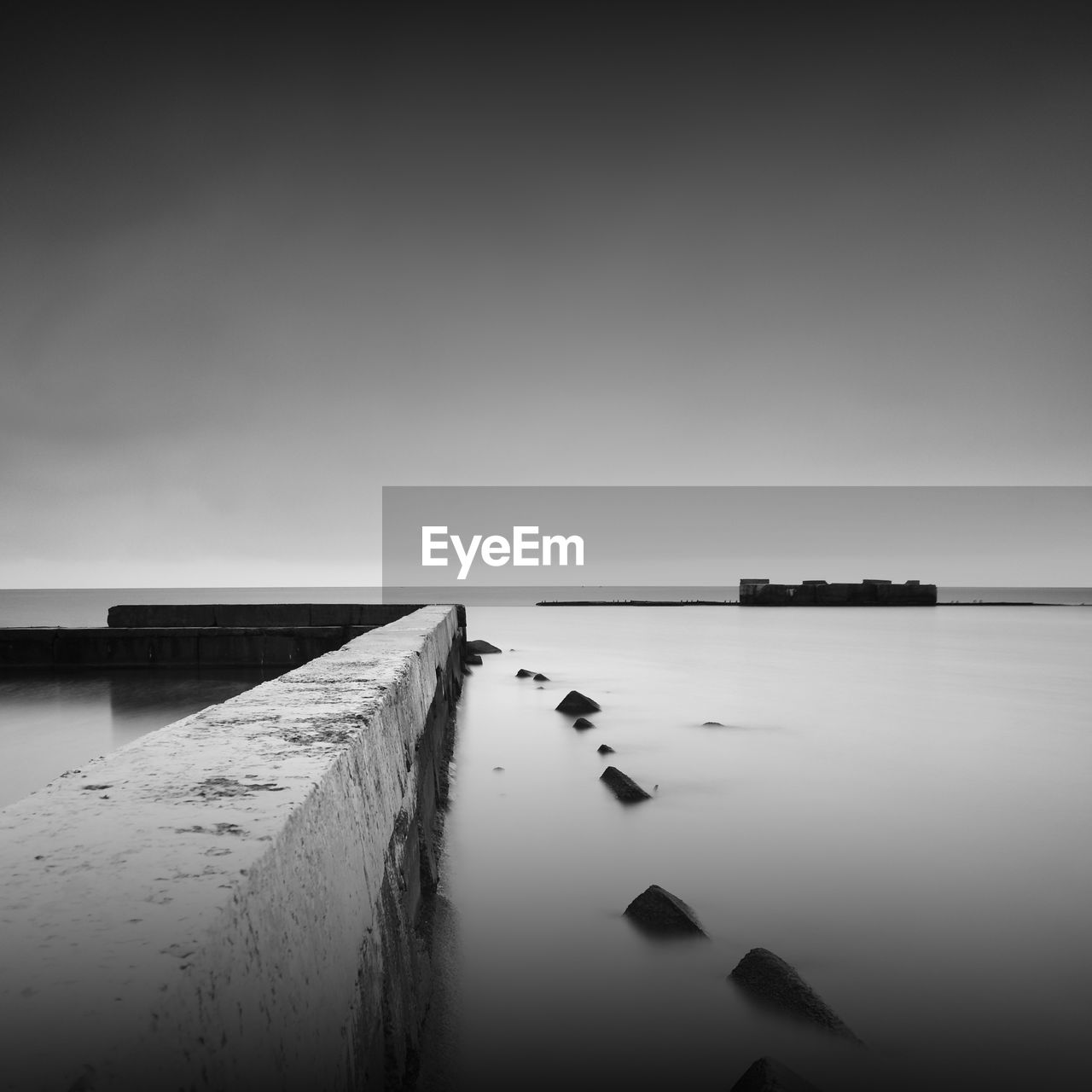 Pier by sea against sky during foggy weather