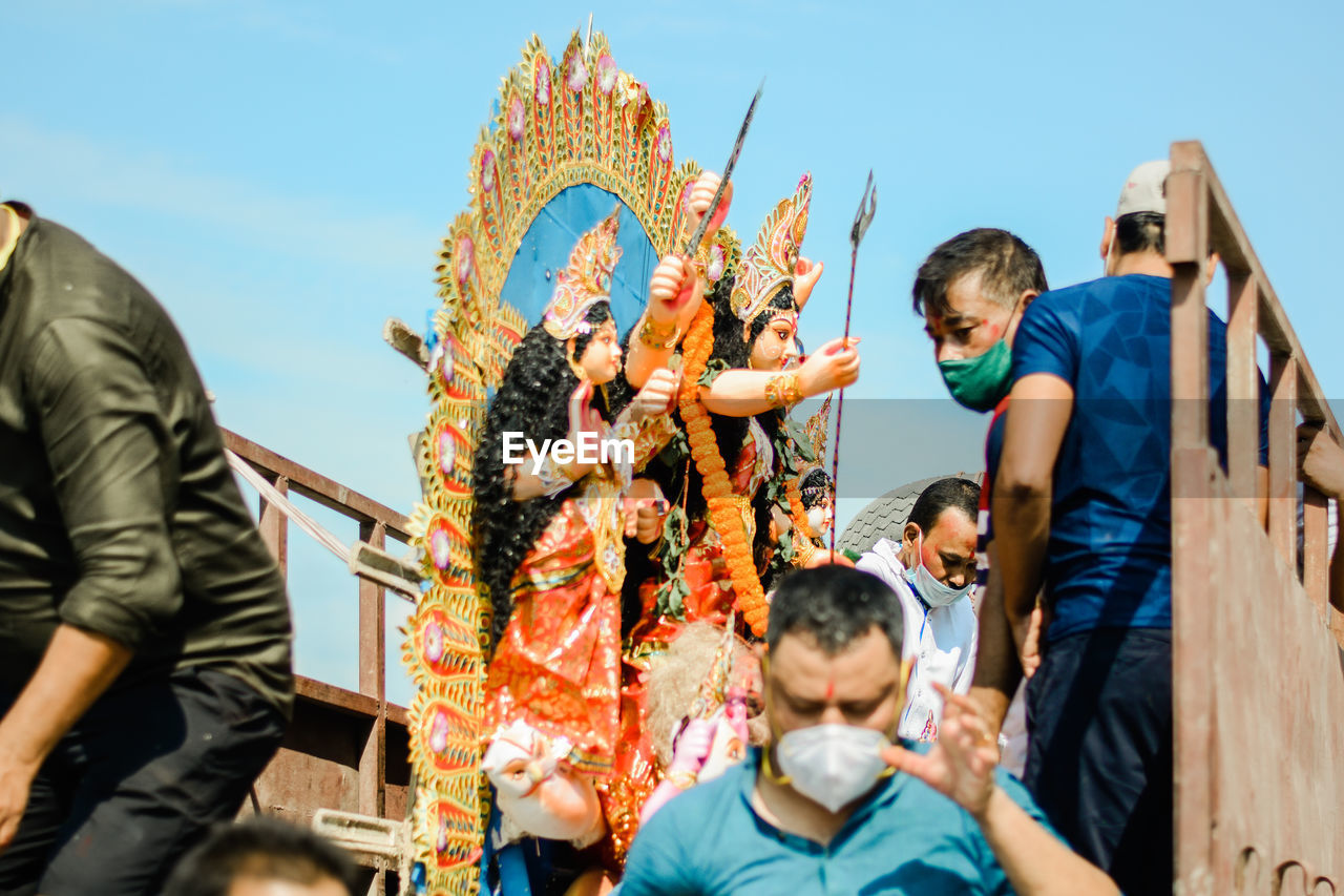 Group of a men carrying an idol of goddess durga for visarjan, guwahati,assam