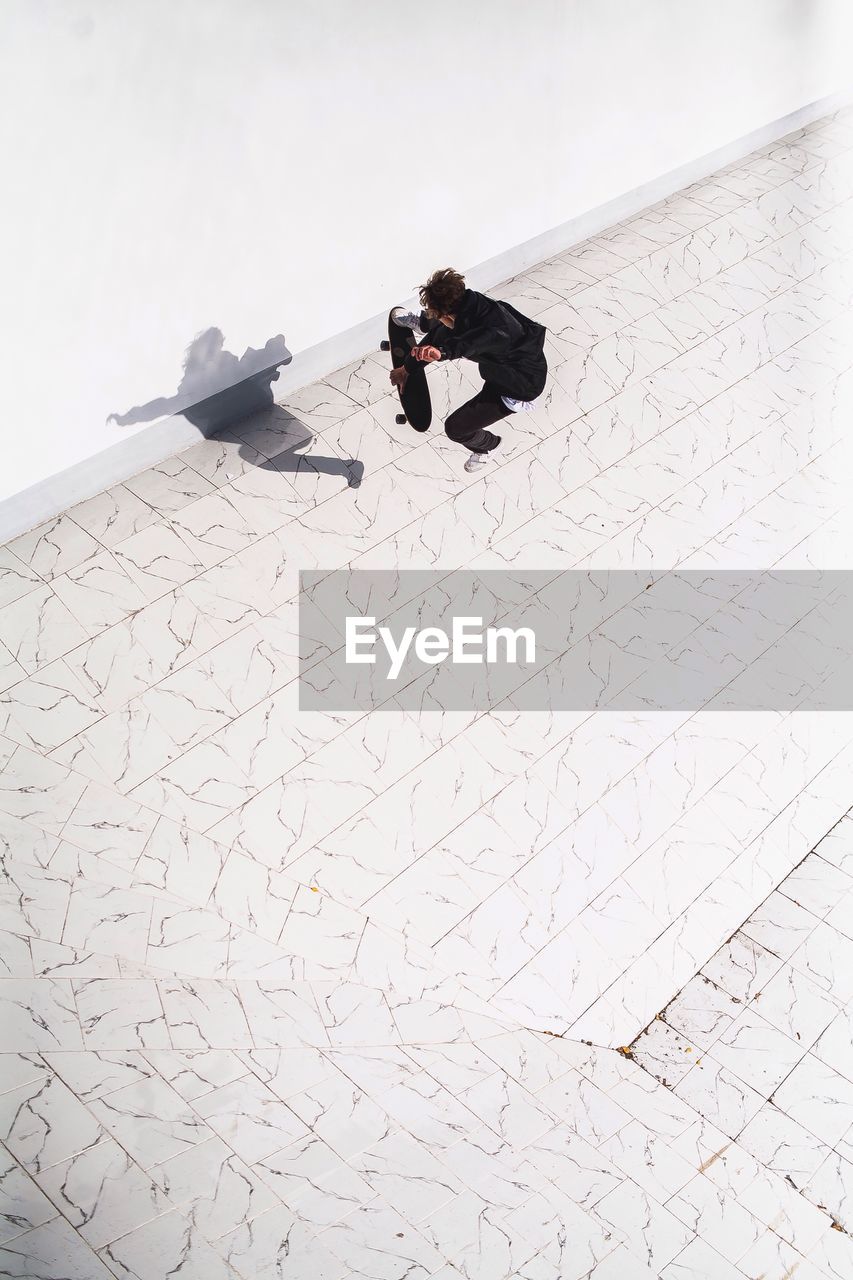 High angle view of man performing stunt on skateboard at park