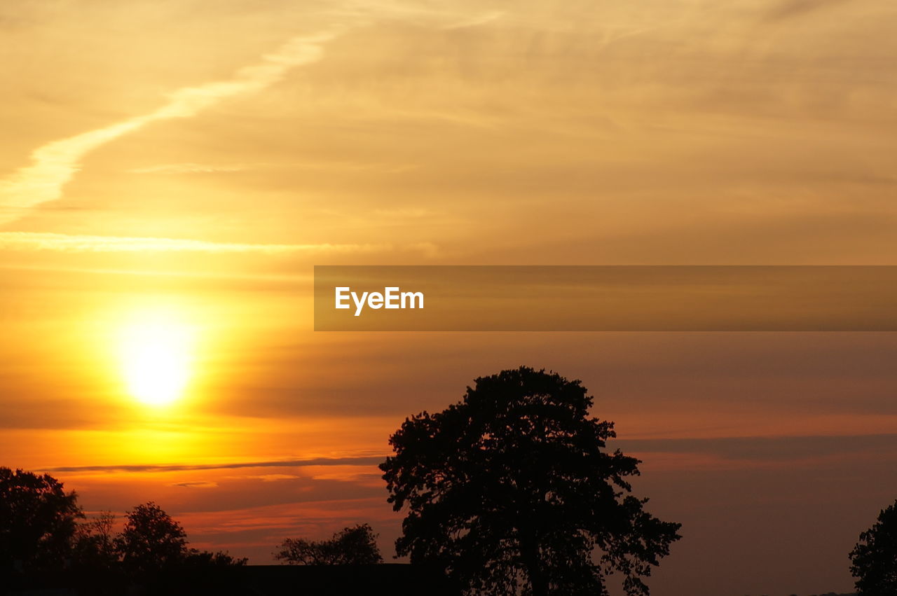 Silhouette of landscape against cloudy sky