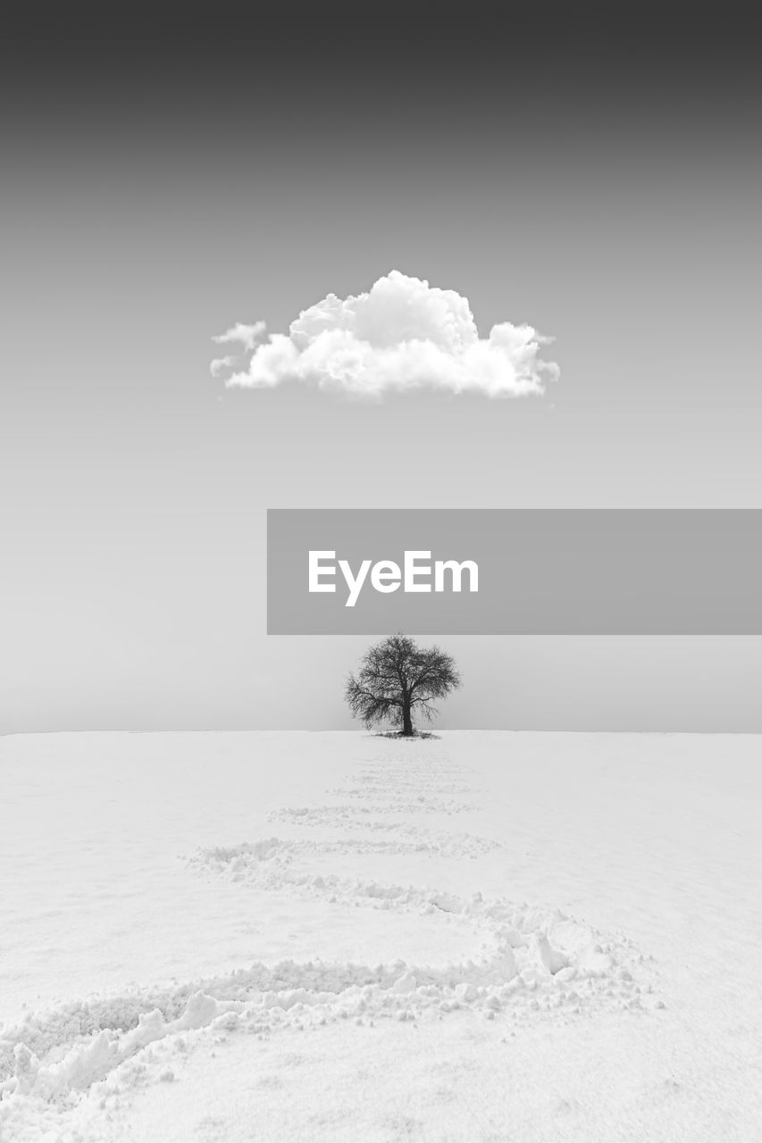 Scenic view of snow covered field against sky