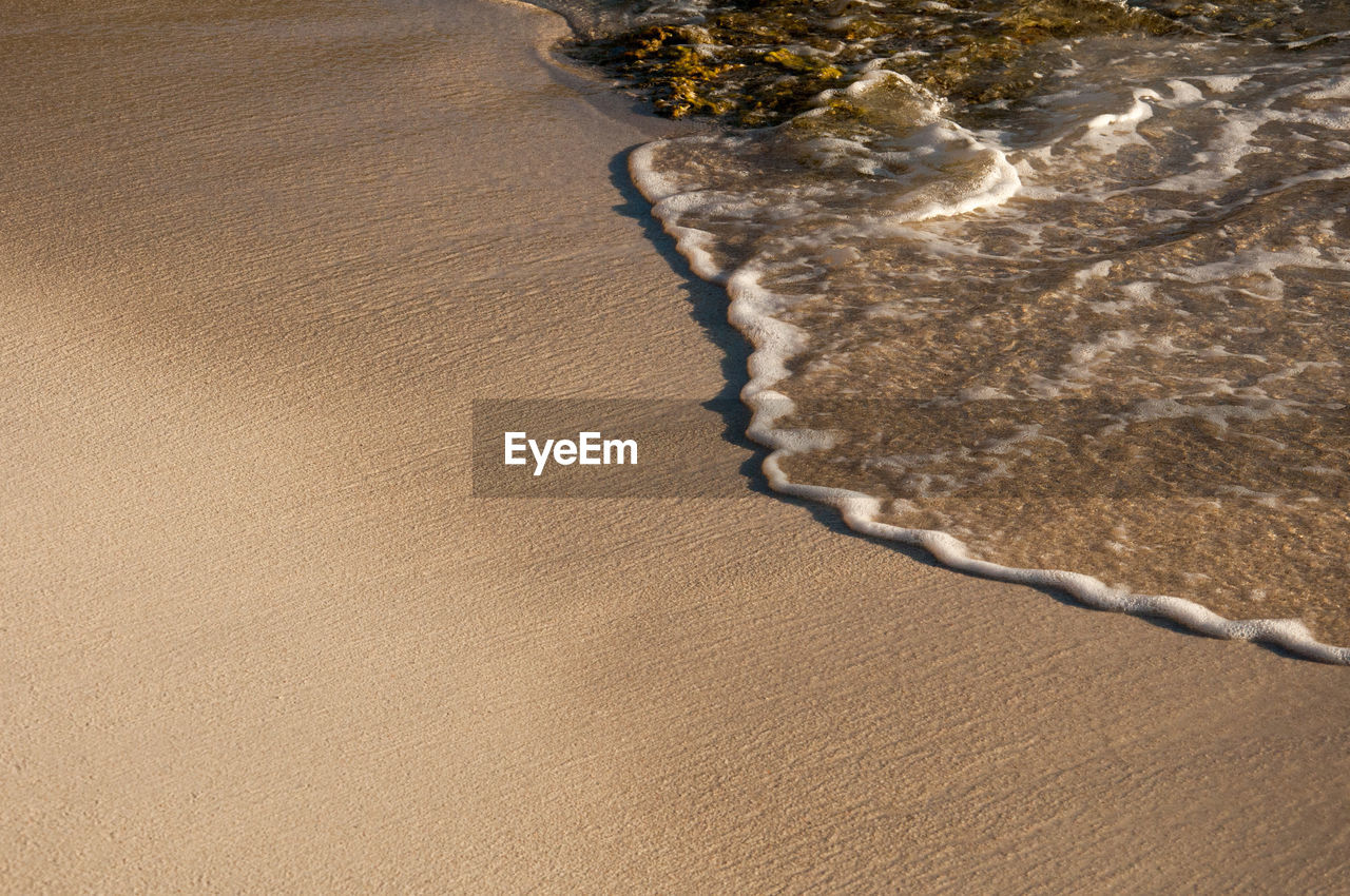 land, sand, beach, nature, water, sea, no people, high angle view, beauty in nature, day, tranquility, scenics - nature, outdoors, environment, sunlight, desert, brown, wave, landscape, tranquil scene, sand dune, pattern