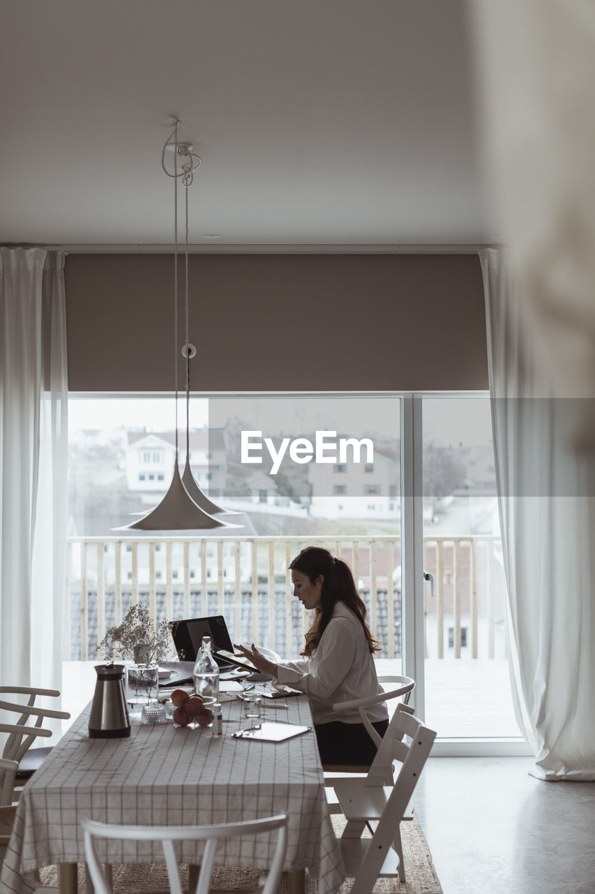 Businesswoman working on laptop at home office