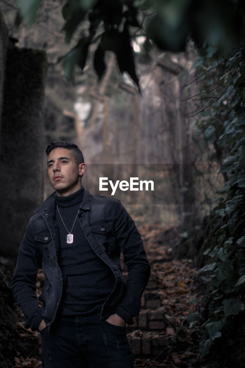 Young man standing in forest