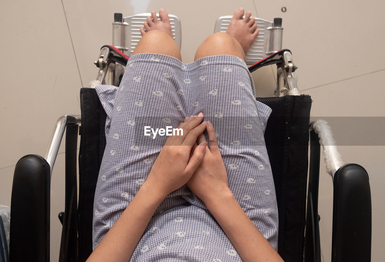 A young woman is riding in a wheelchair. view from above.