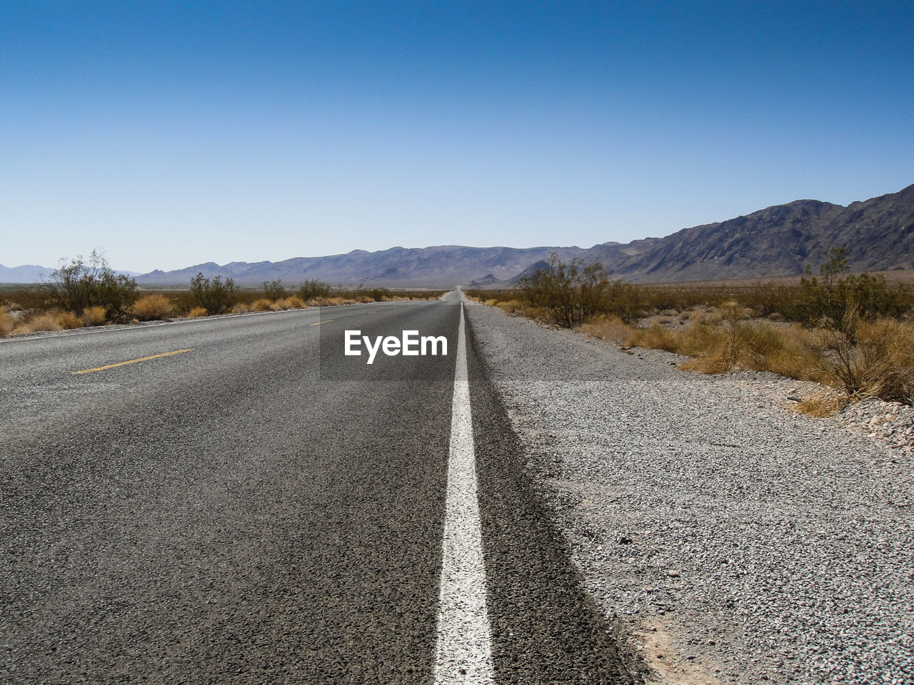 Empty country road along landscape