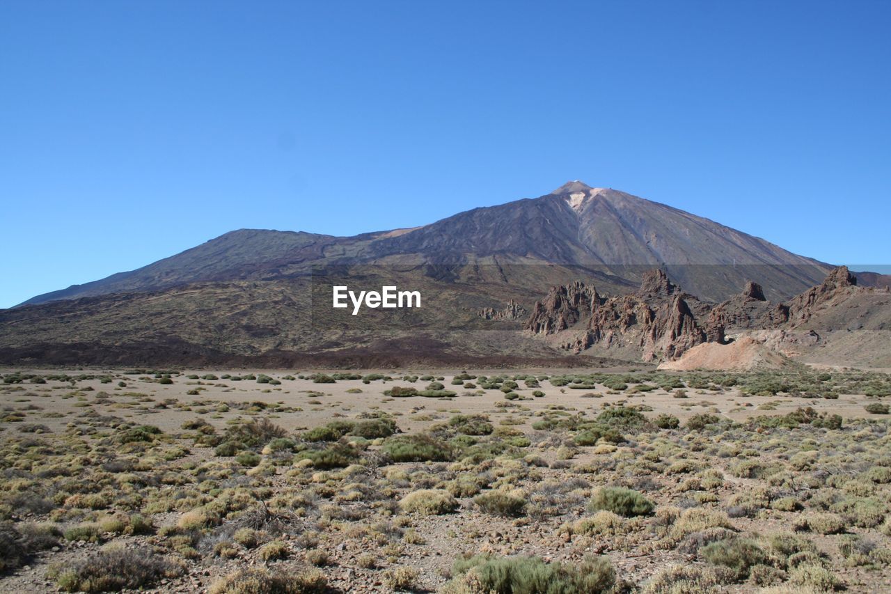 SCENIC VIEW OF VOLCANIC LANDSCAPE AGAINST CLEAR BLUE SKY