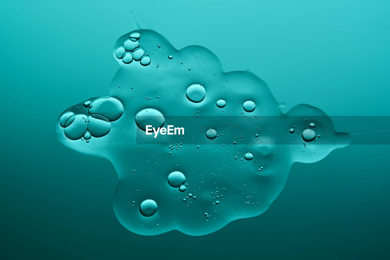 water, blue, drop, bubble, nature, no people, colored background, close-up, studio shot, transparent, abstract, wet, indoors, sea, shape, motion, marine biology, floating, azure, three dimensional, backgrounds, floating on water, simplicity, blue background